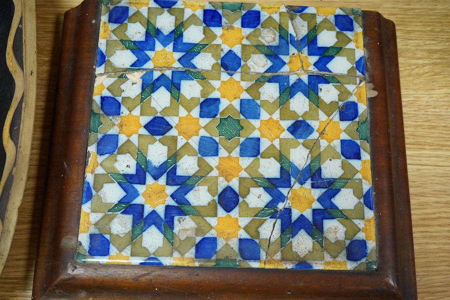 A 19th century pottery slipware baking dish (restored), 34cm wide and a Spanish maiolica tile